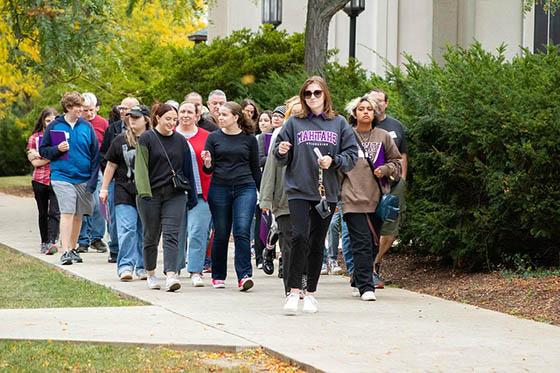 Photo of two Chatham University students walking across the Shadyside Campus, talking and walking down stairs